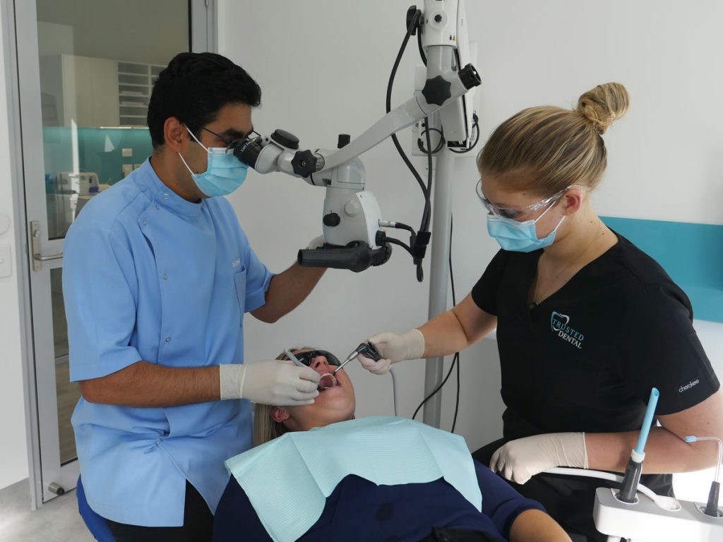 Dr Omid Salar Working with Dental Microscope