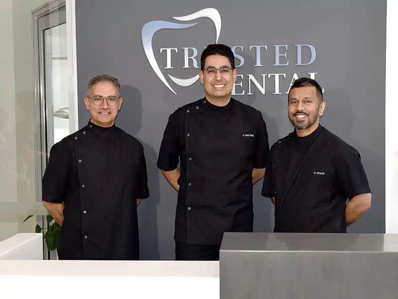 Trusted Dental Dentists - Dr Salar - Dr Ramy - Dr Dharsh in front of logo